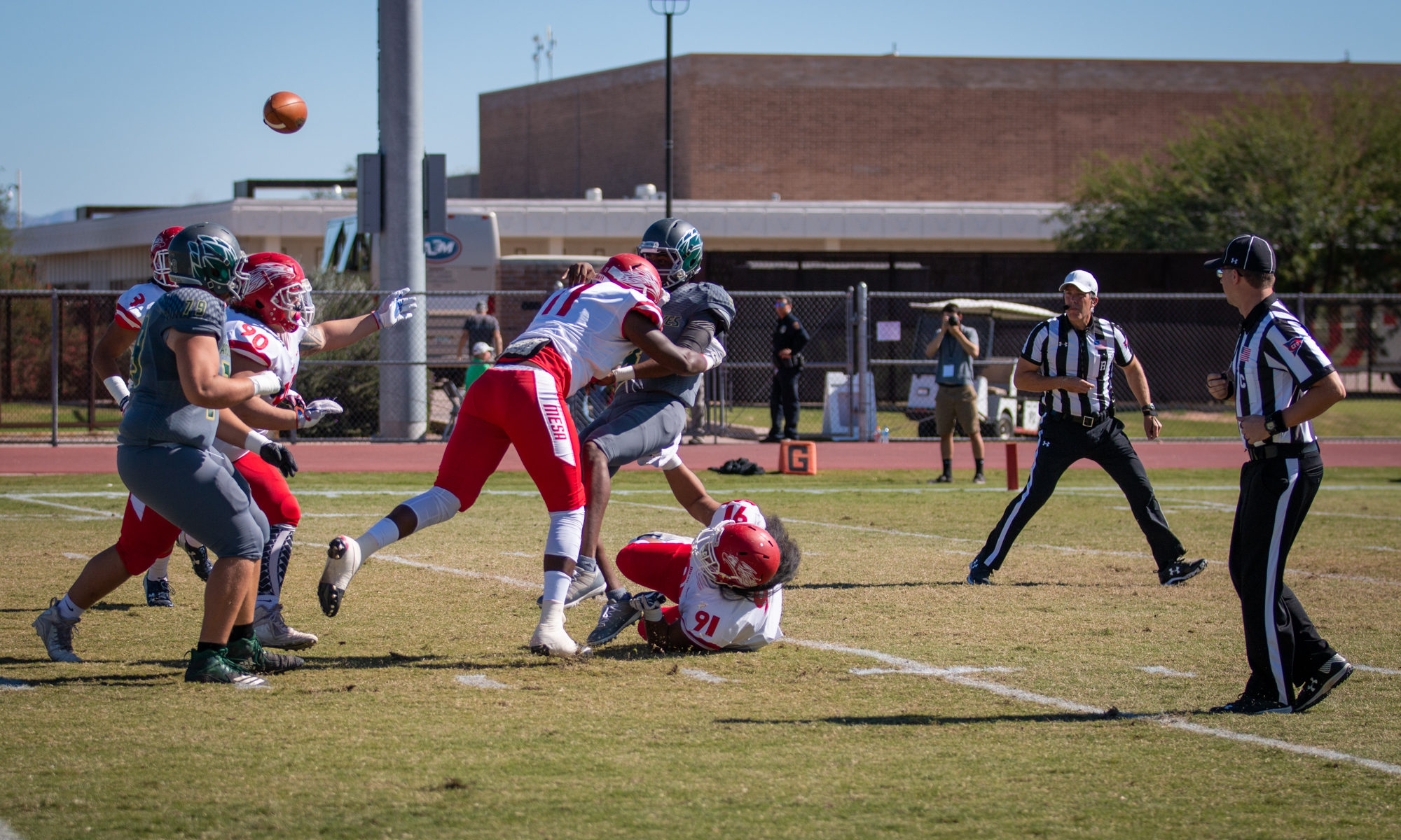 The Mesa defense was stout during the first half of their game with Scottsdale. Sophomore defensive lineman Ronathon Elmore gets the hit on the quarterback. (Photo by Sarah Farrell)
