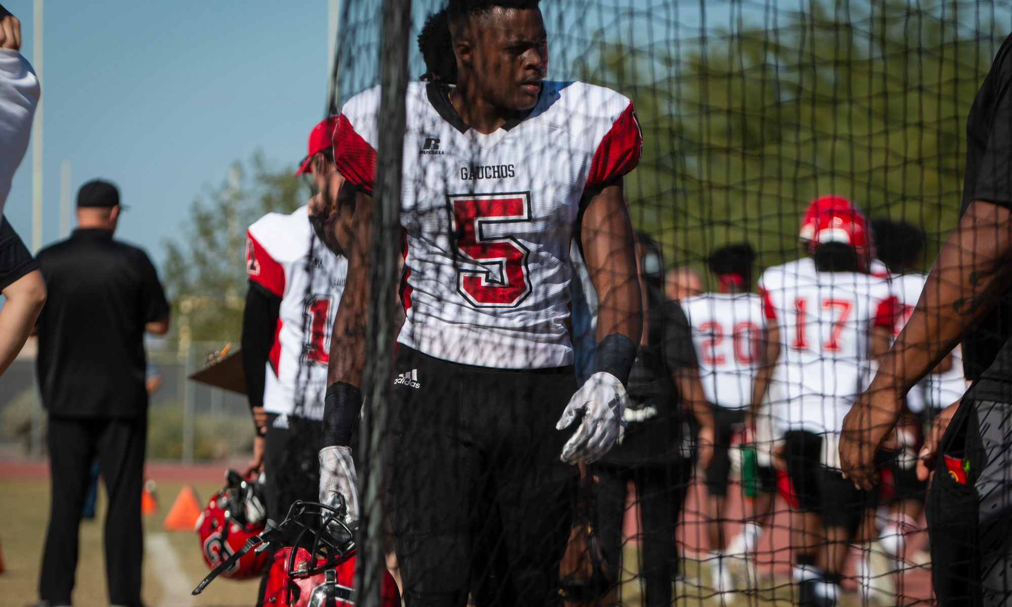 Sophomore Dexter Carter walks the Guacho sideline during their final game of the season against Scottsdale. He is one of dozens of out-of-state players around Maricopa County. (Photo by Sarah Farrell)
