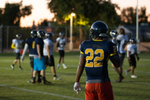 Phoenix College players practice on a back field before their final home game. The Bears have players from around the country, but most are from the Valley. (Photo by Sarah Farrell)