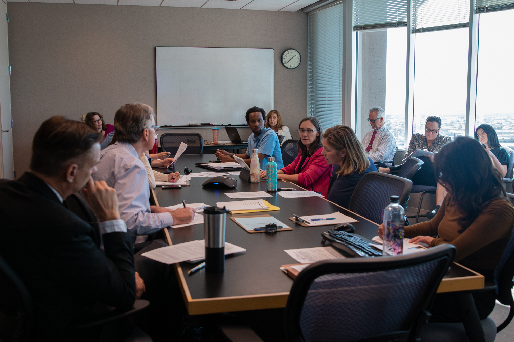 Members of the city's Urban Heat Island/Tree and Shade Subcommittee discuss recommendations for city council to improve canopy coverage in Phoenix. The subcommitteee meets at City Hall once a month. (Photo by Molly Duerig)