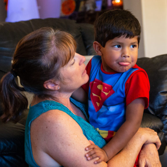 Mimi attempts to calm an energetic Isaac. In addition to her role as a stay-at-home mom, she volunteers with CASA and advocates for foster kids still in the system. (Photo by Lindsay Walker)